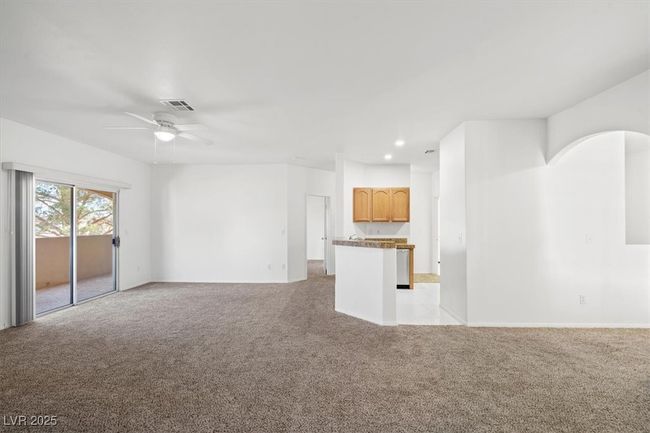 Unfurnished living room with ceiling fan, recessed lighting, visible vents, and light carpet | Image 5