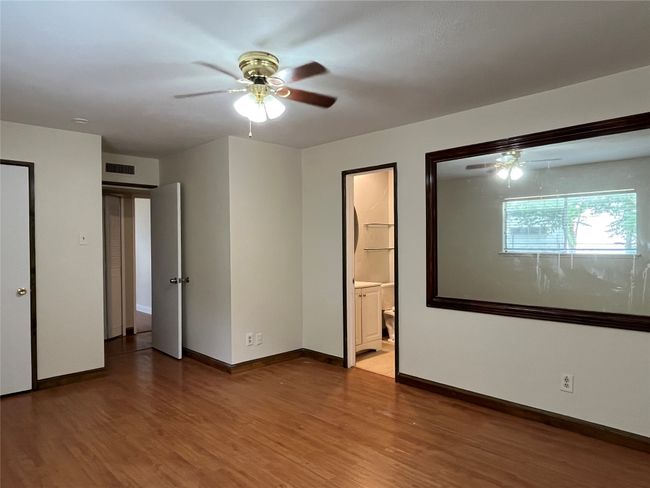 Unfurnished bedroom with wood finished floors, baseboards, and ceiling fan | Image 6