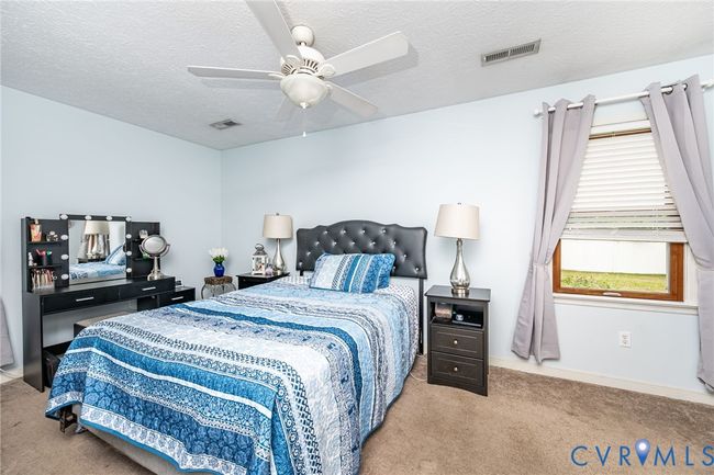 Bedroom featuring carpet, a textured ceiling, and ceiling fan | Image 17