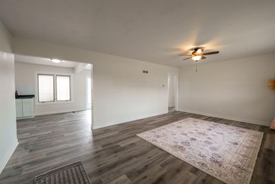 Unfurnished room with dark hardwood / wood-style floors and ceiling fan | Image 3