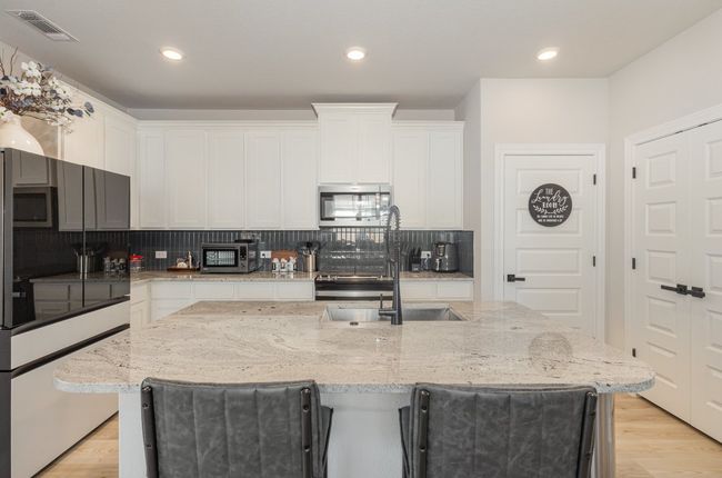 Kitchen with a center island and breakfast bar, and recessed lighting | Image 8