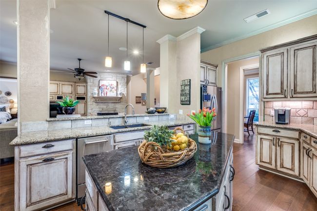 Kitchen with a sink, tasteful backsplash, ceiling fan, stainless steel refrigerator with ice dispenser, and dark wood-type flooring | Image 8