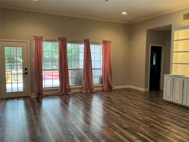 Family room has door leading to covered patio | Image 6