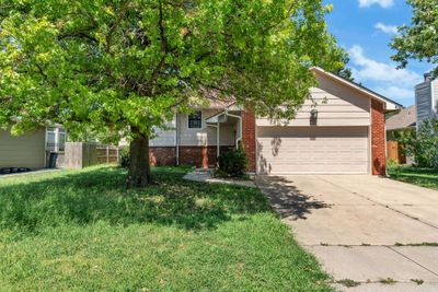 View of front of property with a garage and a front yard | Image 1