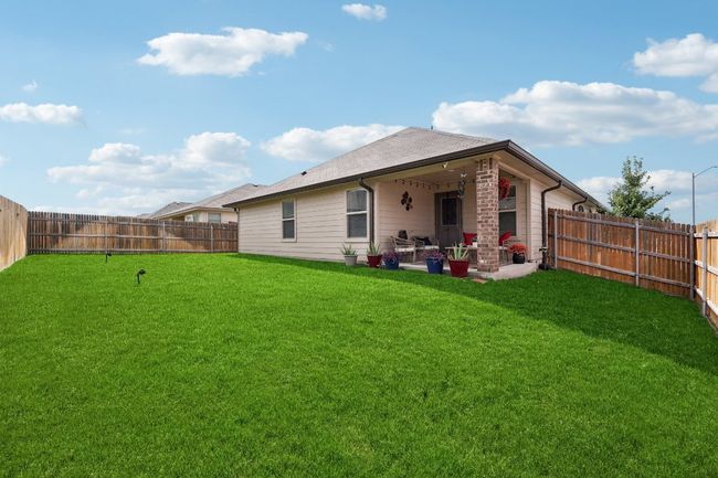 Rear view of property with a fenced backyard and a patio | Image 31