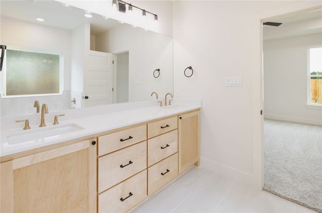 Full bathroom featuring double vanity, baseboards, and tile patterned floors | Image 18