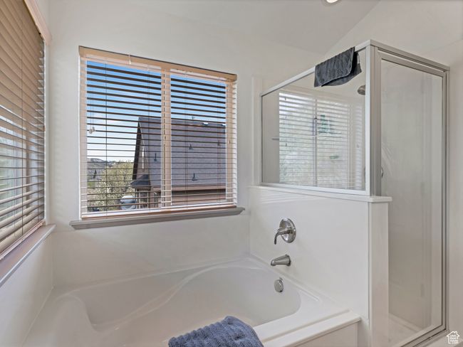 Bathroom featuring a stall shower and a bath | Image 19
