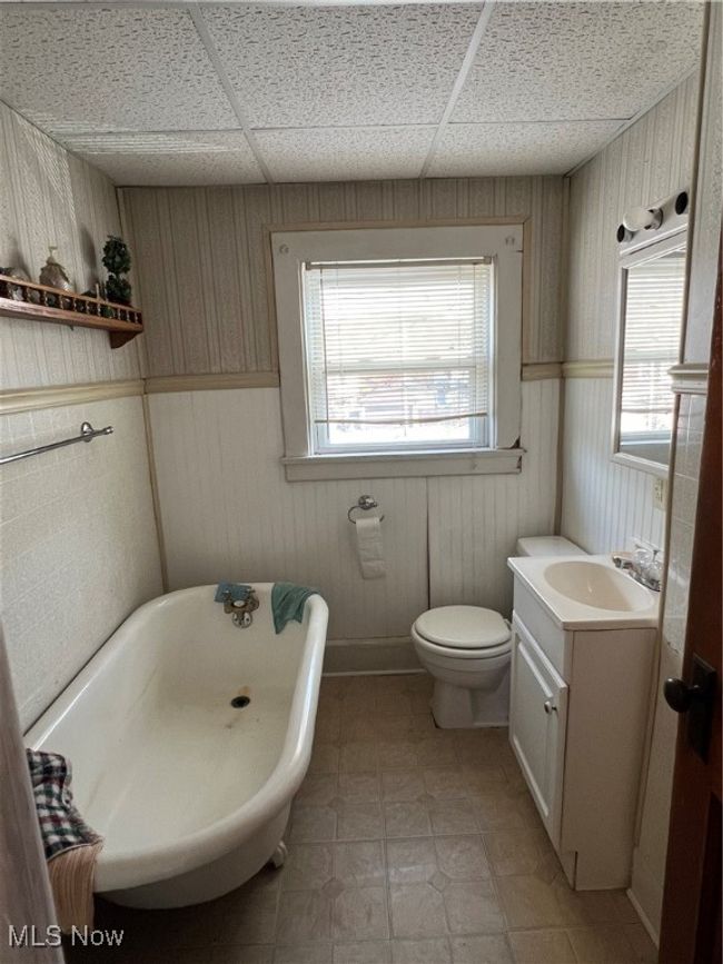 Bathroom featuring vanity, toilet, a drop ceiling, and a bath | Image 10