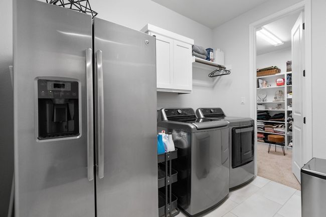 A designated laundry area with tile flooring and W/D connections. | Image 22