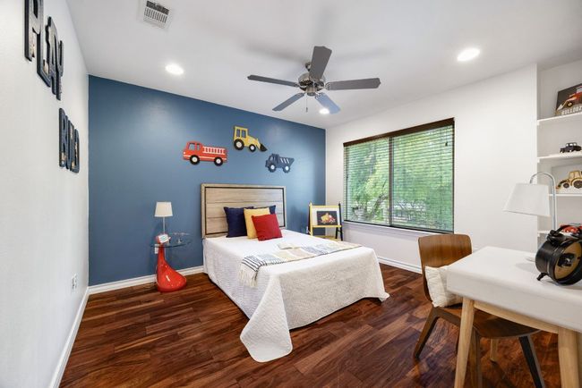 Bedroom featuring wood finished floors, baseboards, recessed lighting, an office area, and ceiling fan | Image 28