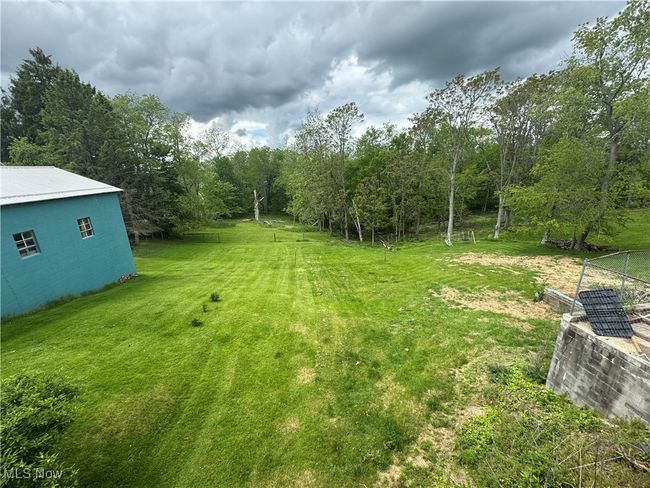 View of green lawn with a wooded view | Image 28