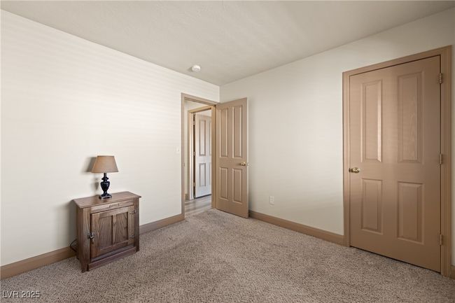 Unfurnished bedroom with light carpet and baseboards | Image 29
