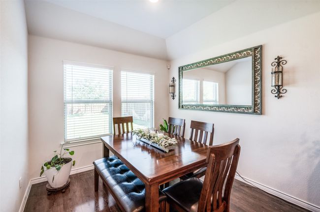 Dining area with dark wood-type flooring and baseboards | Image 16