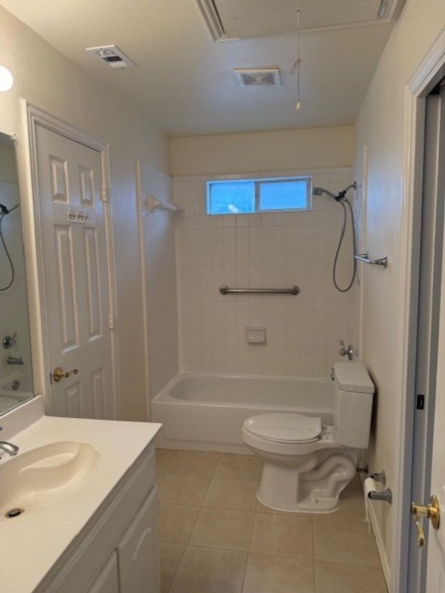 Full bathroom with vanity, bathtub / shower combination, and tile patterned floors | Image 19