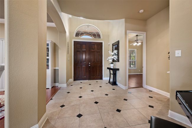 Entrance foyer with arched walkways, light tile patterned floors, and ceiling fan | Image 5