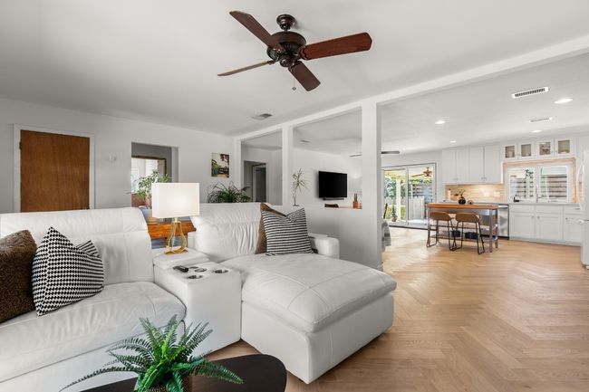Living area featuring a ceiling fan, recessed lighting, and visible vents | Image 6