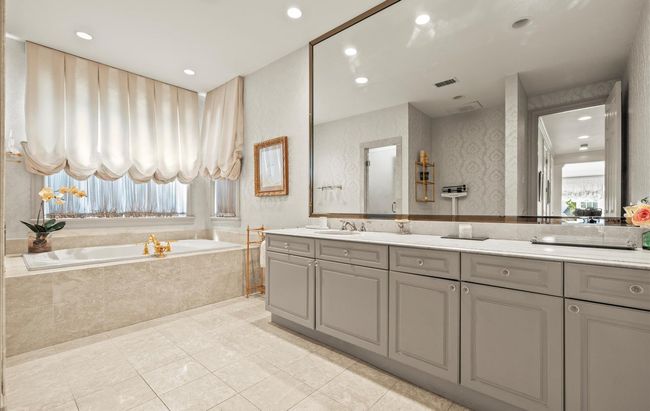 Full bath featuring double vanity, plenty of natural light, a bath, tile patterned floors, and recessed lighting | Image 24