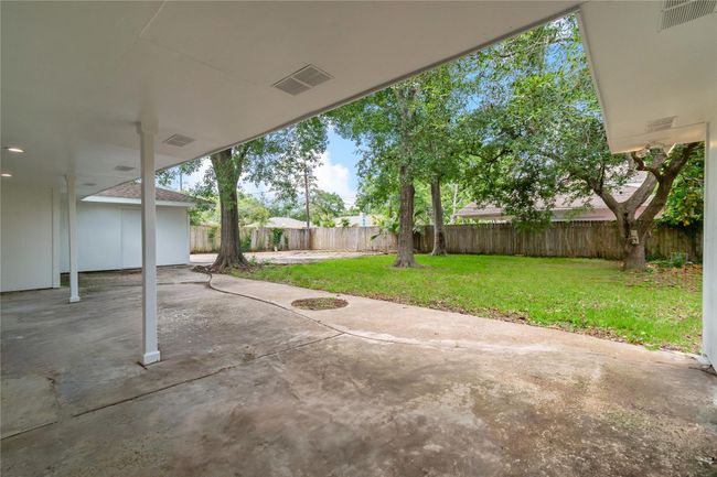 View of covered back porch overlooking back yard. | Image 4