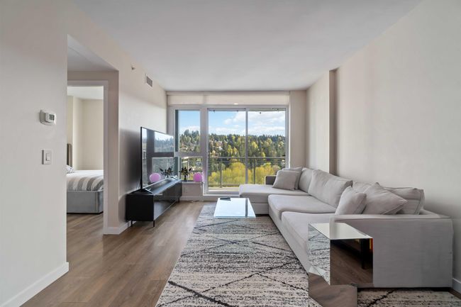 Living area featuring wood finished floors, visible vents, and baseboards | Image 7