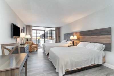 Bedroom featuring access to outside, a textured ceiling, floor to ceiling windows, and wood-type flooring | Image 2