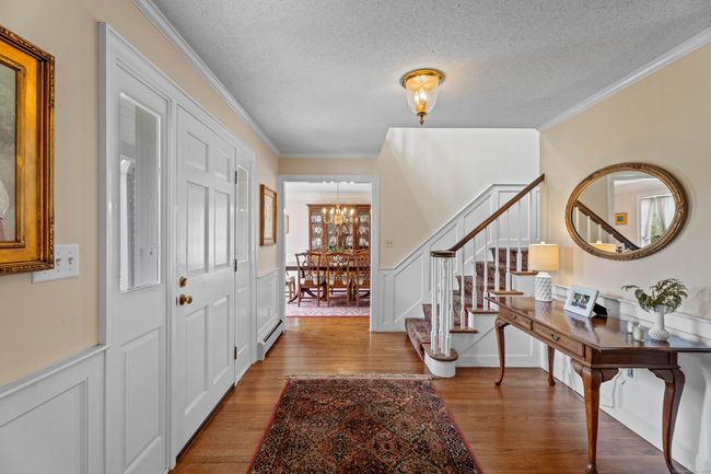 Enter a gracious foyer with turned custom staircase | Image 6