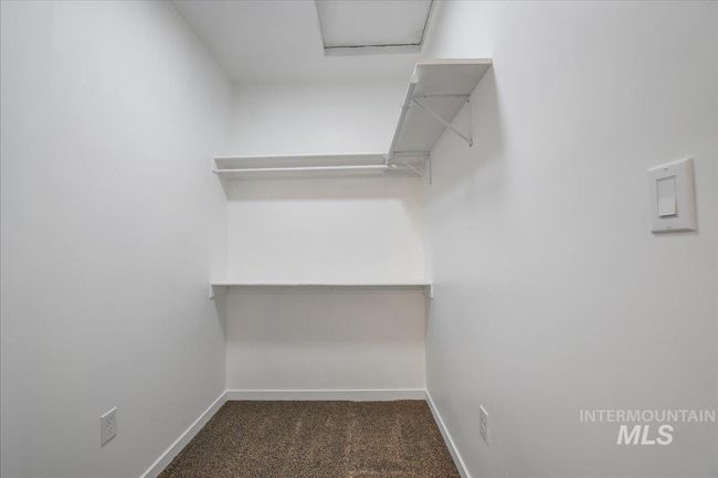 Spacious closet featuring attic access and carpet flooring | Image 20