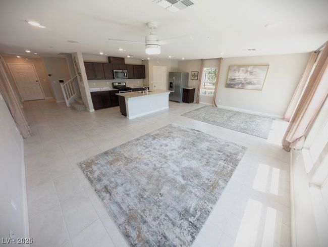 Kitchen with appliances with stainless steel finishes, open floor plan, light countertops, dark brown cabinets, and recessed lighting | Image 7