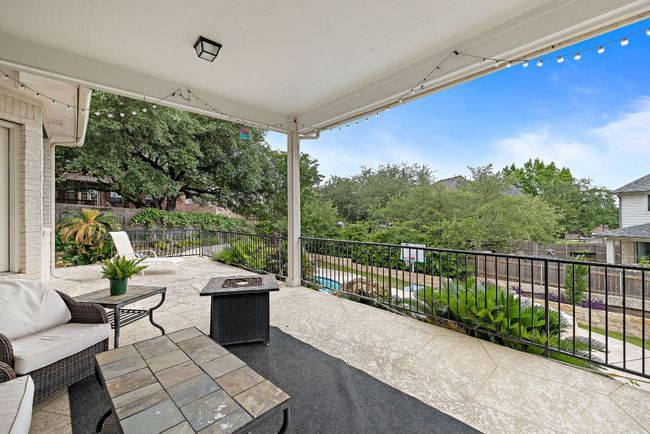Covered patio that looks out over the pool. | Image 36