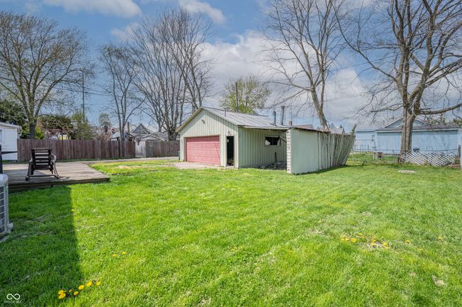 view of yard featuring an outdoor structure, fence, and a garage | Image 24