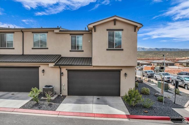 View of property with driveway, central air condition unit, a garage, stucco siding, and a mountain view | Image 4