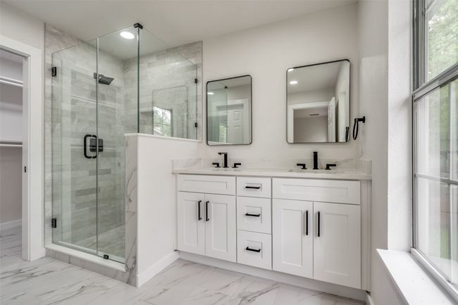 Full bathroom featuring a shower stall, double vanity, marble look tile flooring, a walk in closet, and recessed lighting | Image 23