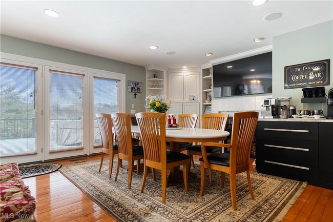 This is a large dinette area. This shows the doors to lead out to the deck. This seller has created a deluxe coffee bar. | Image 14