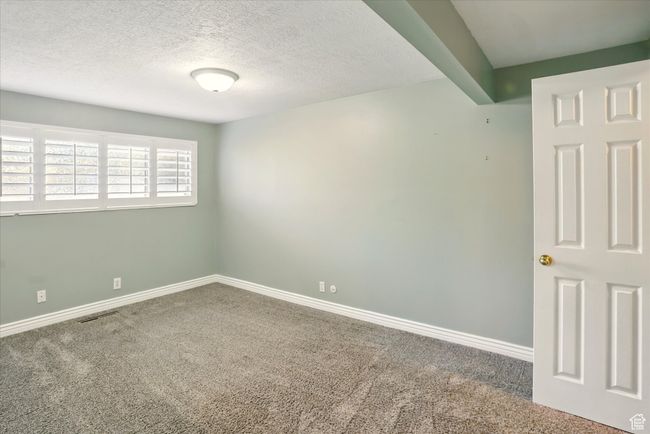 Carpeted spare room featuring baseboards and a textured ceiling | Image 16