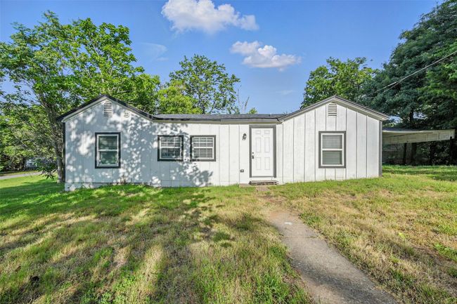 View of front of property featuring a front lawn and board and batten siding | Image 19