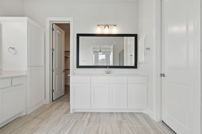 Bathroom featuring a ceiling fan, vanity, and a stall shower | Image 17