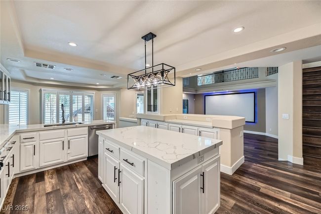 Kitchen featuring a center island, dishwasher, a peninsula, dark wood-style flooring, and recessed lighting | Image 14