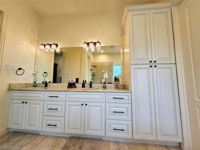 Full bath with double vanity, tiled shower, and tile patterned floors | Image 26