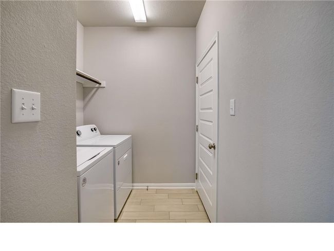 Laundry room featuring independent washer and dryer and baseboards | Image 22