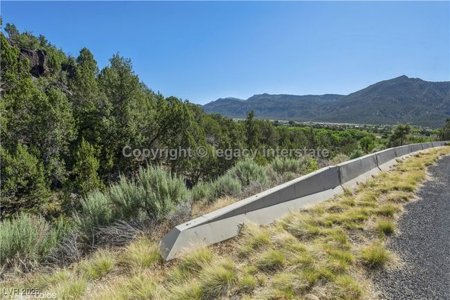 View of mountain backdrop featuring a heavily wooded area | Image 7