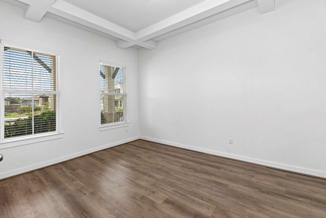 Empty room featuring beamed ceiling, dark wood-type flooring, and baseboards | Image 4