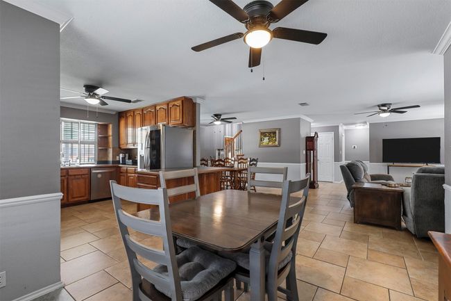 Tiled dining room featuring ornamental molding and ceiling fan | Image 21