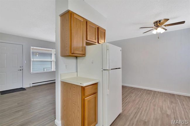 Kitchen with LVP floors, a textured ceiling, and white refrigerator | Image 8