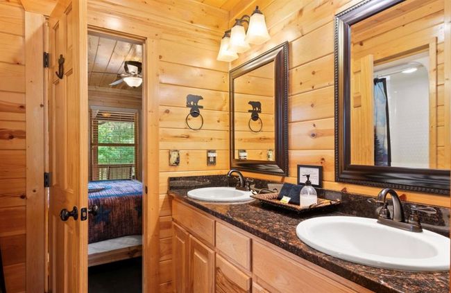 Bathroom with wood walls, double vanity, connected bathroom, and a ceiling fan | Image 25