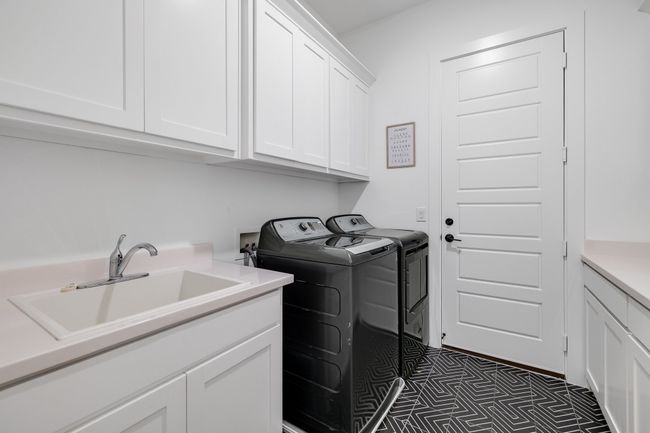 Clothes washing area featuring washer and clothes dryer and cabinet space | Image 16