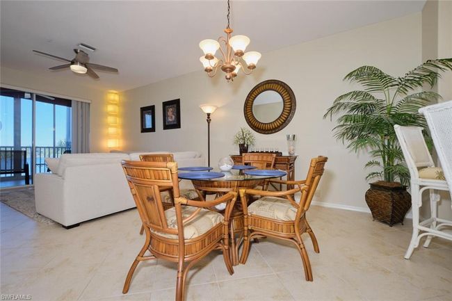 Tiled dining area featuring ceiling fan with notable chandelier | Image 25