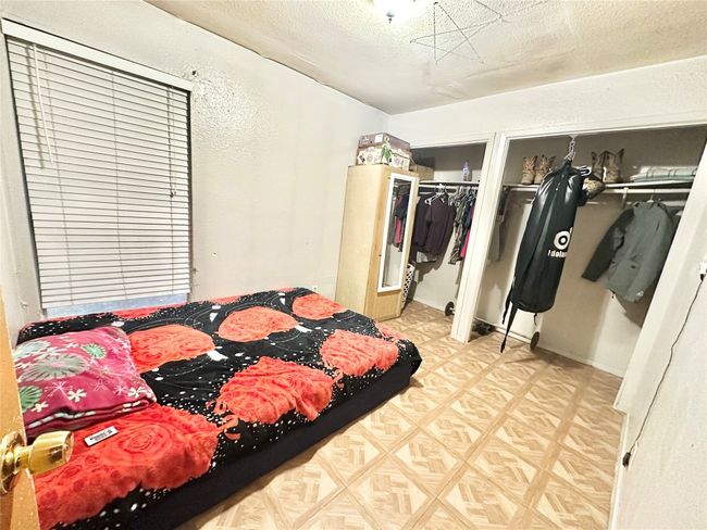 Bedroom featuring two closets and a textured ceiling | Image 26