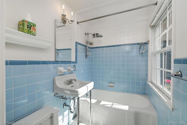 Bathroom featuring tile walls, bathtub / shower combination, and a wainscoted wall | Image 21