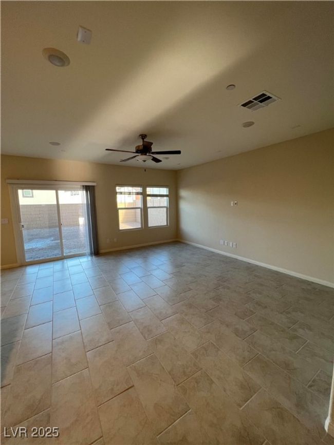 Empty room with a ceiling fan and baseboards | Image 9