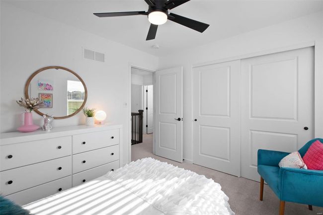 Carpeted bedroom with ceiling fan and a closet | Image 24