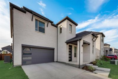 View of front facade with a garage, central air condition unit, and a front lawn | Image 2